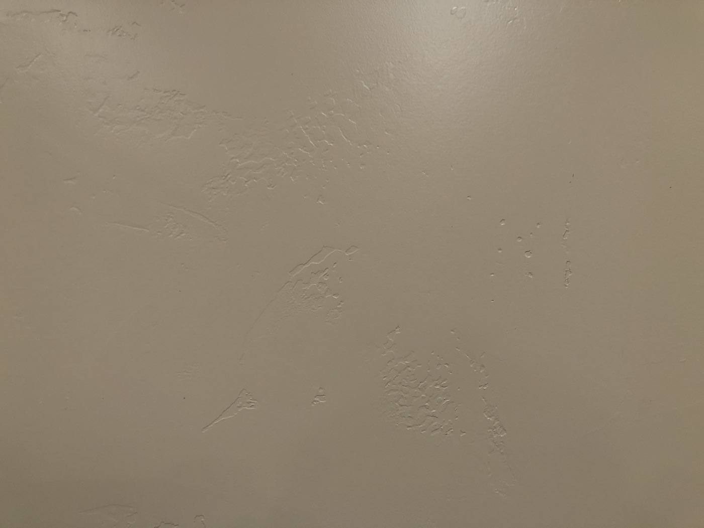 Close-up of a hand-applied custom wall texture with a soft troweled pattern